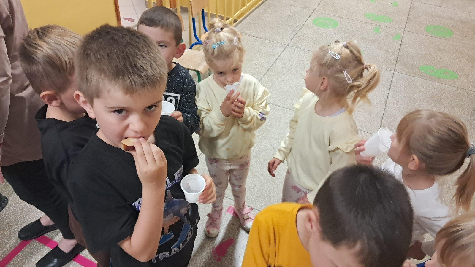 Dzieci degustują jabłka i sok z jabłek.