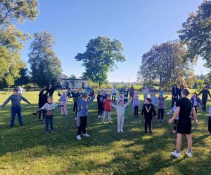 Uczniowie podczas rozgrzewki na boisku szkolnym