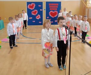 Dziewczynka i chłopiec z grupy 5- i 6-latków recytują przy mikrofonie