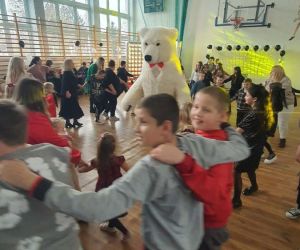 uczniowie tańczą z białym misiem