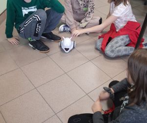 Czworo uczniów programuje robota Photon