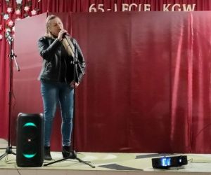 Osoba śpiewa na scenie.