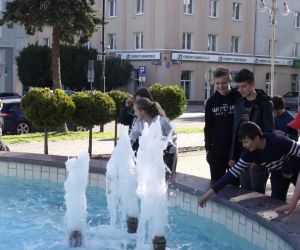 Uczniowie przed fontanną na skwerku w Świdniku