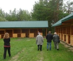 Pięć osób przechodzących obok nowo postawionych pawilonów