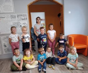 Zdjęcie przedstawia grupę dzieci pozującą do zdjęcia z umalowanymi przez animatora twarzami.