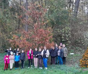 Zdjęcie przedstawia grupę uczniów przy Dębach Katyńskich