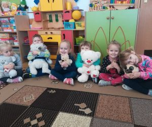 Młodsze przedszkolaki z pluszowymi misiami.