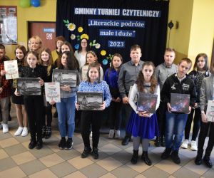 Zdjęcie przedstawia grupę osób pozujących z nagrodami.