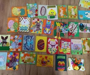 Zdjęcie przedstawia rozłożone na stole kartki wielkanocne.