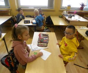  Dzieci pracujące w grupach , wykonują zadania o bezpieczeństwie na drodze