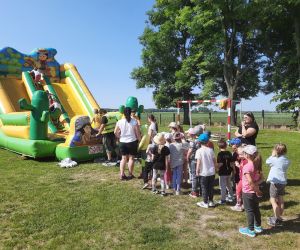 Uczniowie na dmuchanej zjeżdżalni