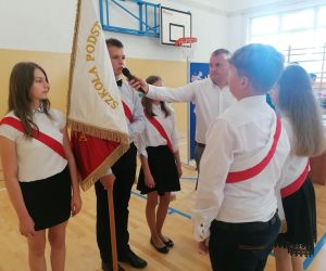 Starsi uczniowie przekazują sztandar szkoły młodszym