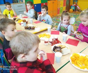 Przedszkolaki wspólnie konsumują andrzejkowe przysmaki