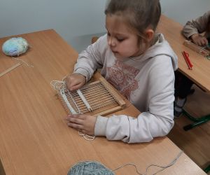 Dziewczynka rozpoczyna pracę z krosnem