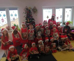 Mikołaj stoi wśród dzieci z oddziału przedszkolnego