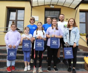 Uśmiechnięte dzieci pozują do zdjęcia, w rękach trzymają nagrody