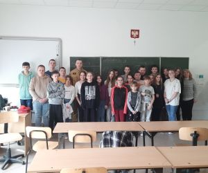 Strażak i uczestnicy spotkania na wspólnym zdjęciu