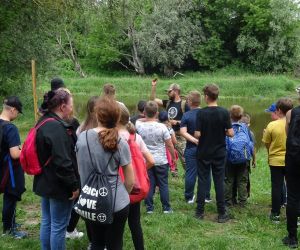 Dzieci stoją w grupie na świeżym powietrzu.