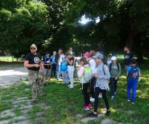 Dzieci na świeżym powietrzu uczą się zastosowania kompasu.